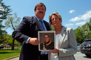 Phil Walker and his wife Maureen hold up a photo of their late son James, who was killed in 2011 in a car accident.